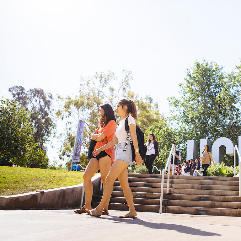 Students walking by UC Riverside's Bell Tower